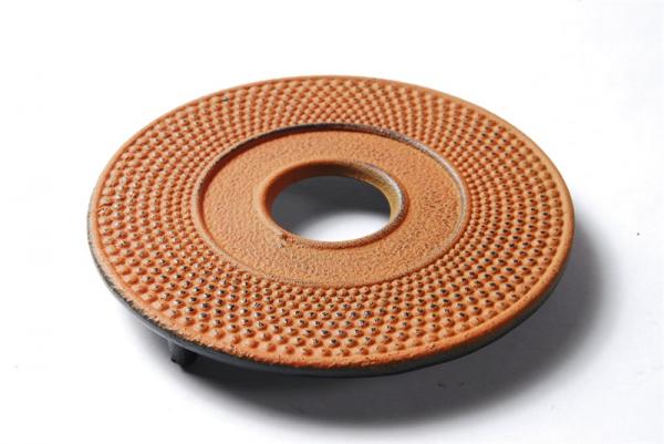 orange cast iron teapot trivet